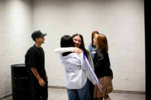 A group of people standing around each other
